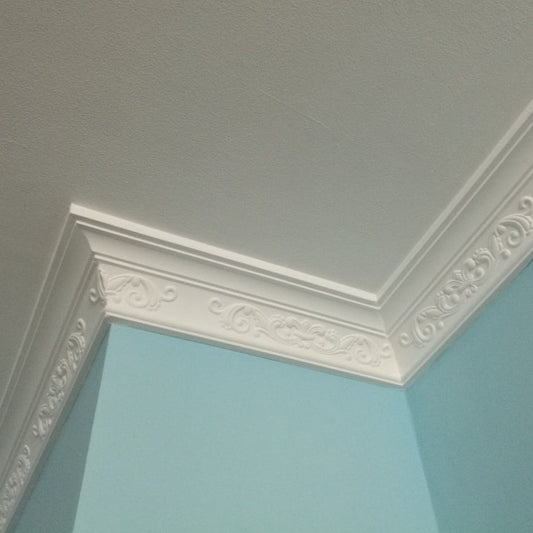 Classic fleur de lys plaster coving in blue room