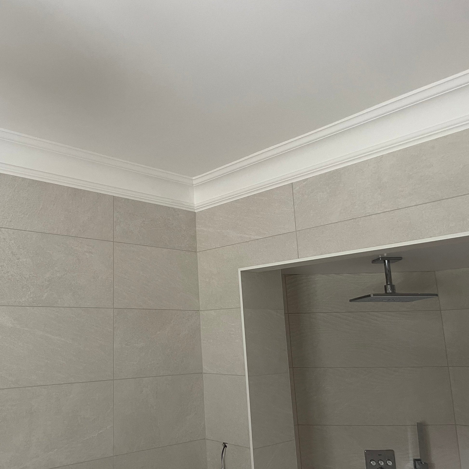 corner section of plaster swan neck coving in bathroom