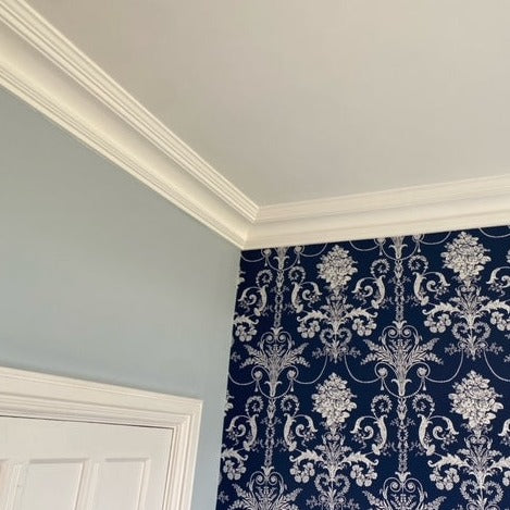 Classic victorian plaster cornice with blue wallapaper