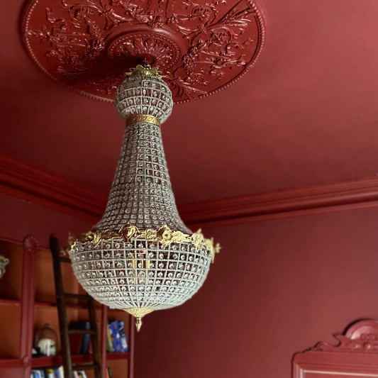 Victorian Ceiling rose drenched in deep red.