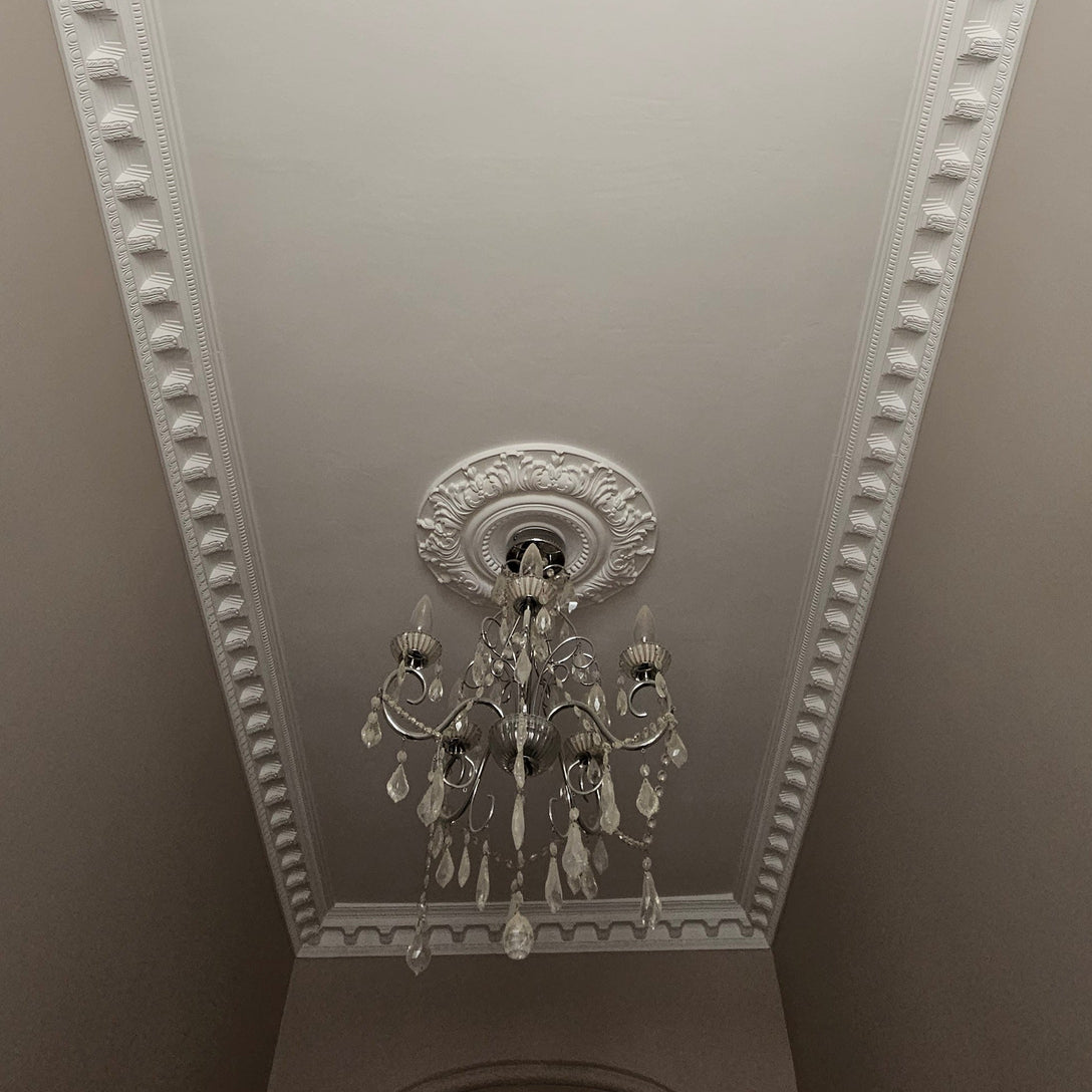dentil plaster coving shown with ceiling rose and chandelier
