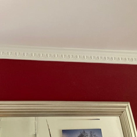 small egg and dart plaster coving shown in red room