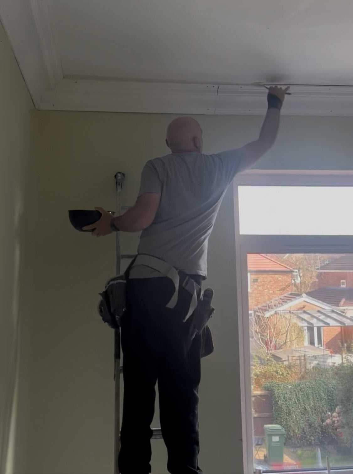 fitter installing plaster coving