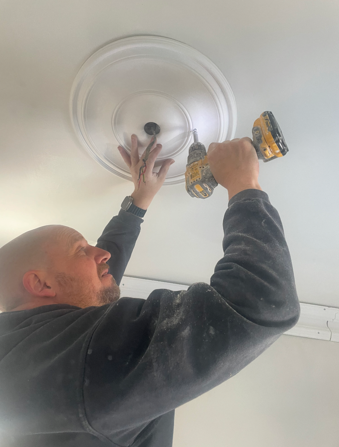 plain spun plaster ceiling rose being installed