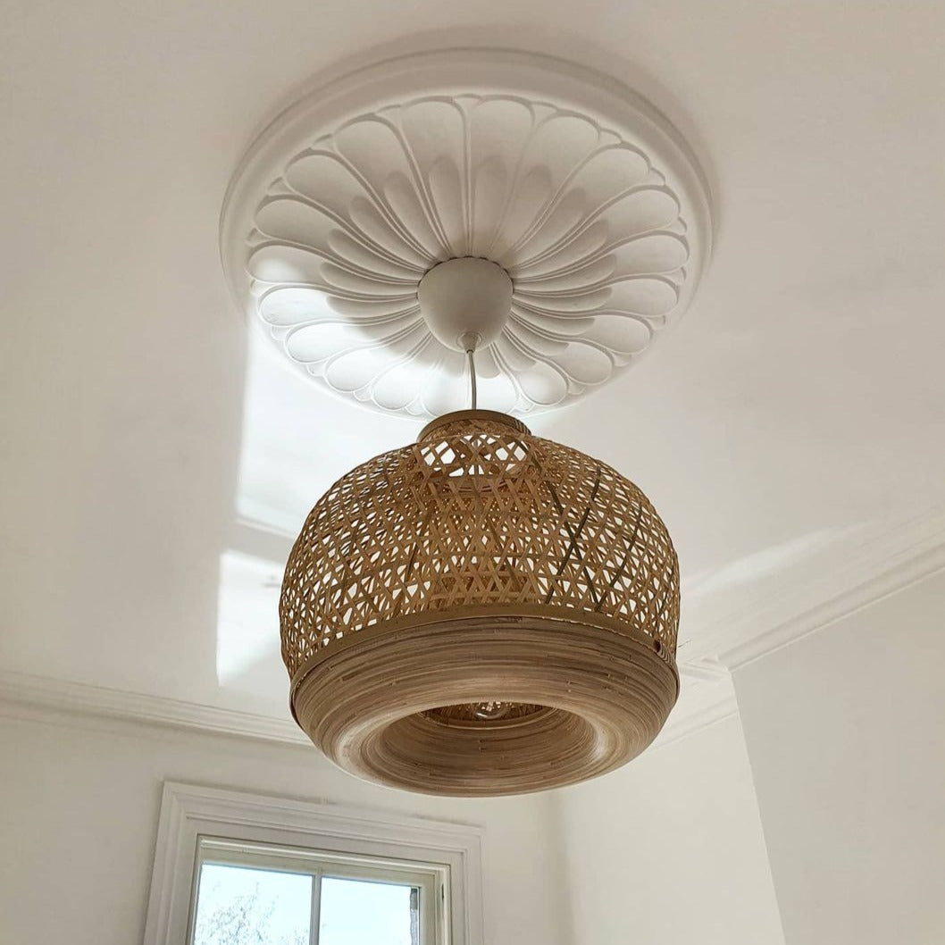 art deco floral plaster ceiling rose shown with basket chandelier in bright room
