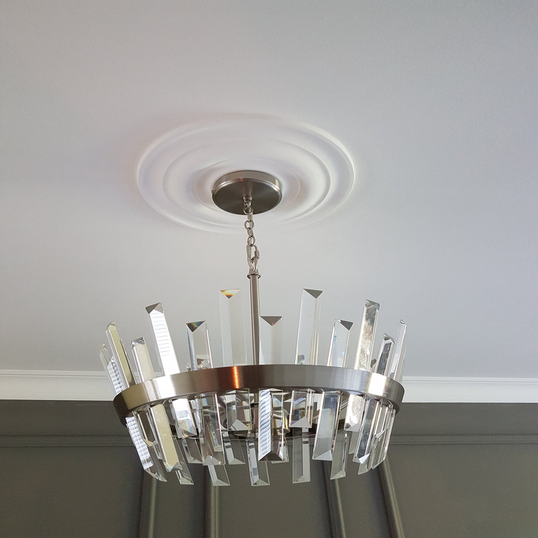 simple plain plaster ceiling rose shown with chandelier