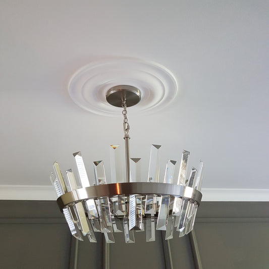 simple plain plaster ceiling rose shown with chandelier