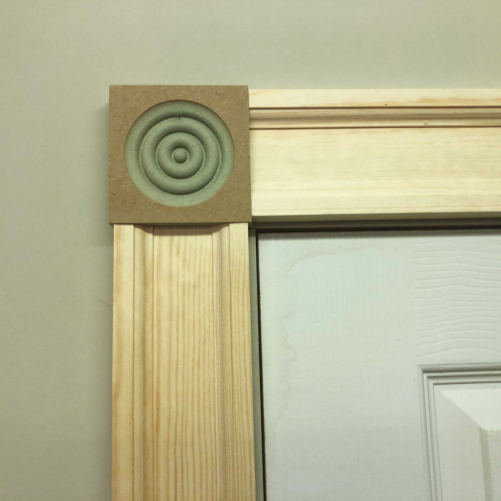 corner of Victorian Timber Architrave fitted around a door -20mm x 91mm