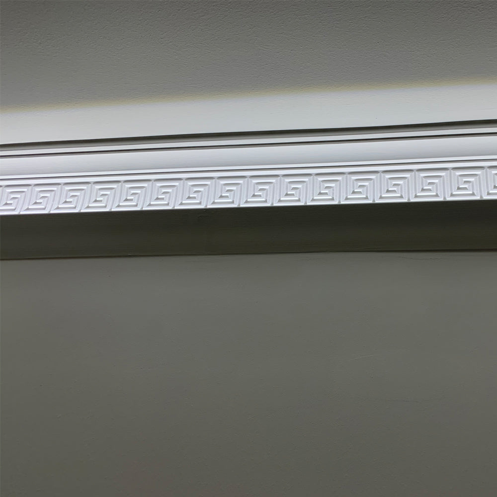 Greek Key cornice against well-lit wall