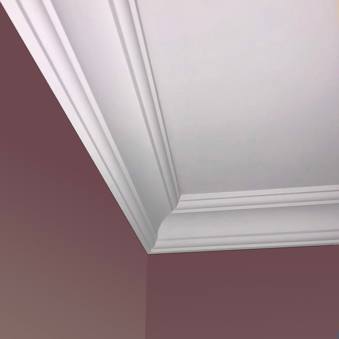 corner of Classic elegant Plaster Coving shown on a pink wall - 85MM