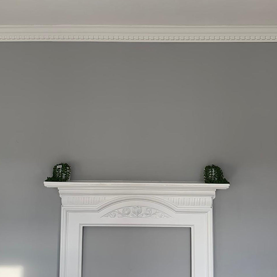 Dentil cornice above fireplace