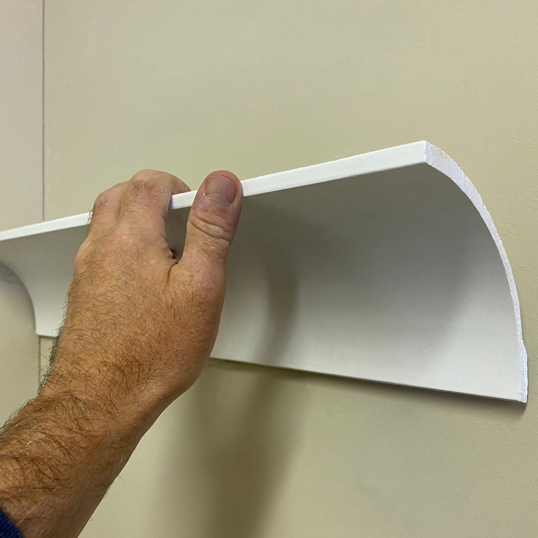 technical photo showing simple Plaster Coving with hand for size comparison - 100mm Drop 