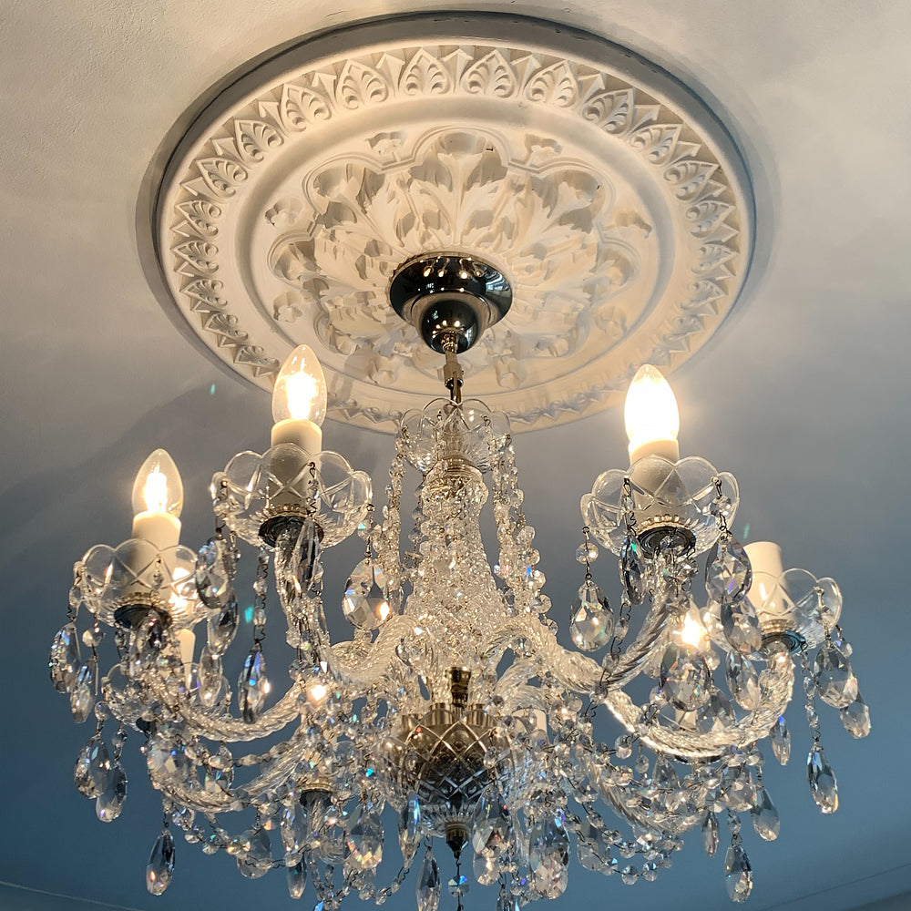 Ornate Victorian Plaster Ceiling Rose in warm lighting