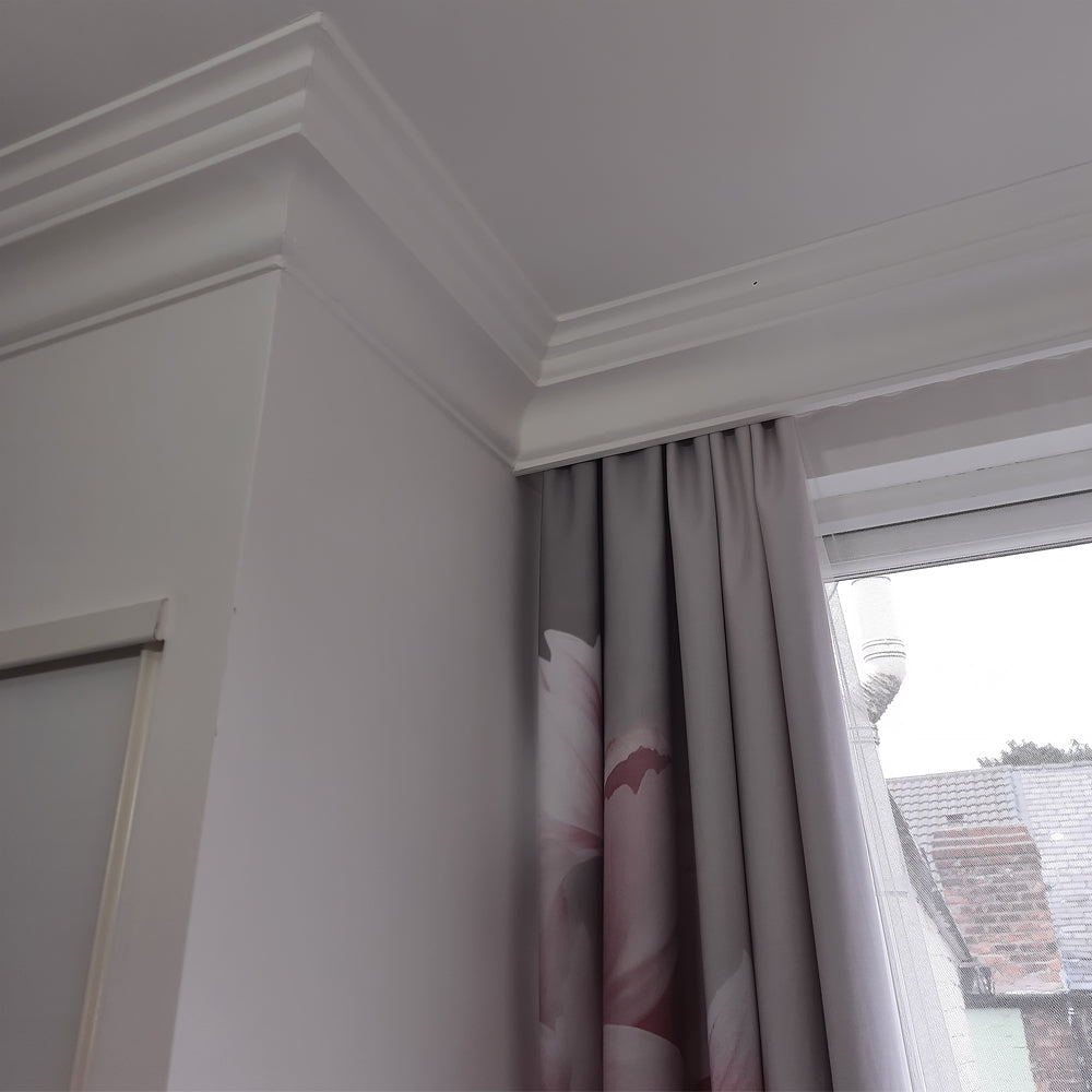 image shows victorian plaster cornice fitted around curtains