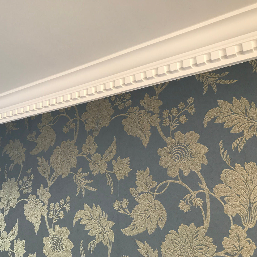 Dentil cornice against feature wallpaper