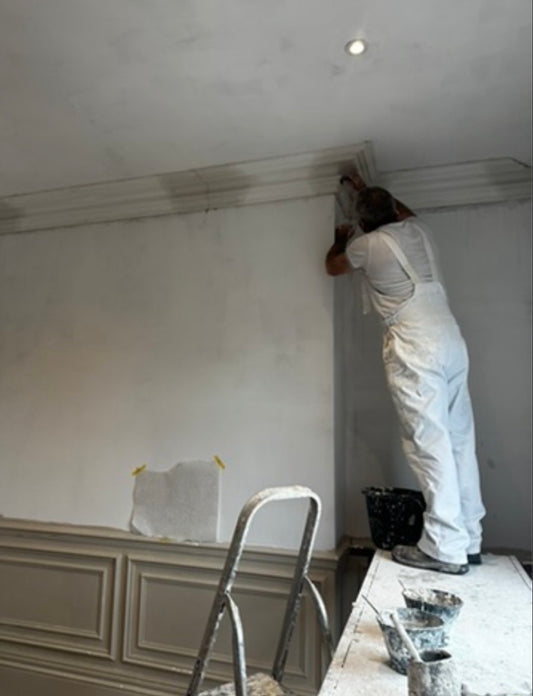 Swan neck plaster coving being installed