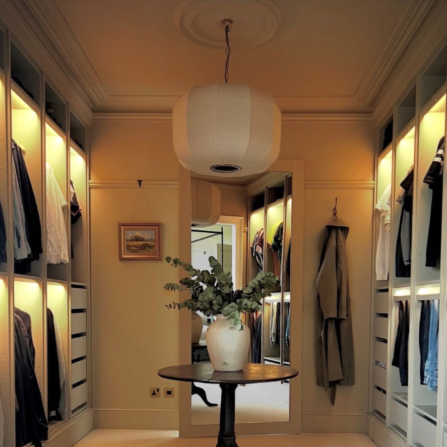 walk-in wardrobe framed by plaster coving