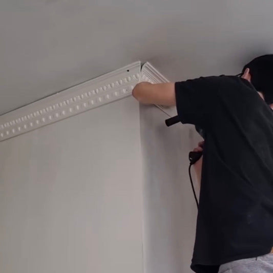 man fitting plaster coving 