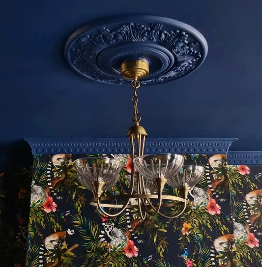 Ornate plaster ceiling rose and coving fitted in blue room