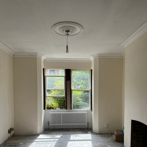 Victorian swan neck plaster coving and ornate rose in living room