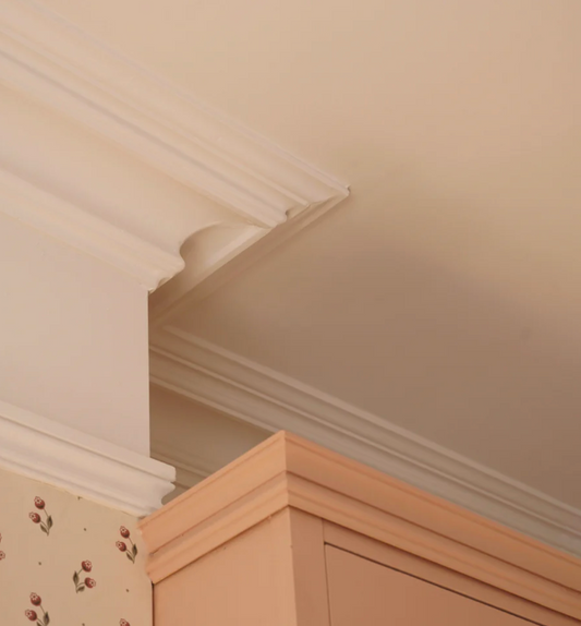 close up victorian swan neck plaster cornice