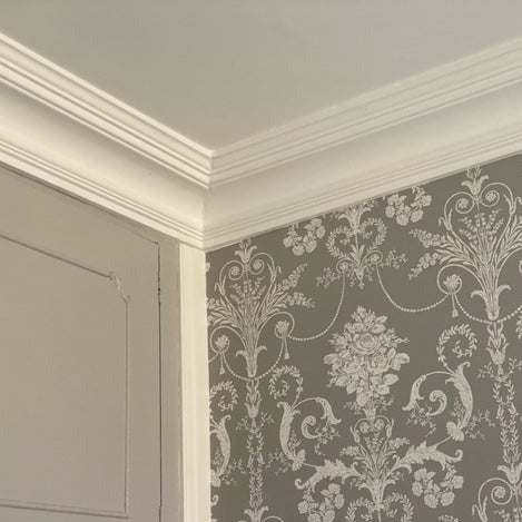classic victorian plaster cornice with floral wallpaper