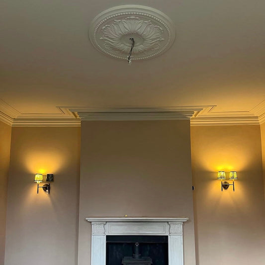 Victorian plaster ceiling rose being fitted in living room