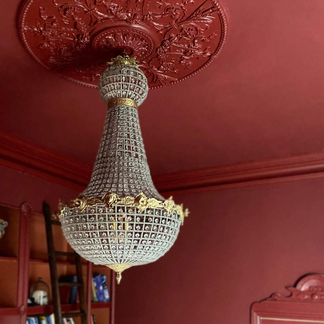 Victorian Ceiling rose drenched in deep red. 