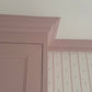 Close up of plaster coving finished in pink