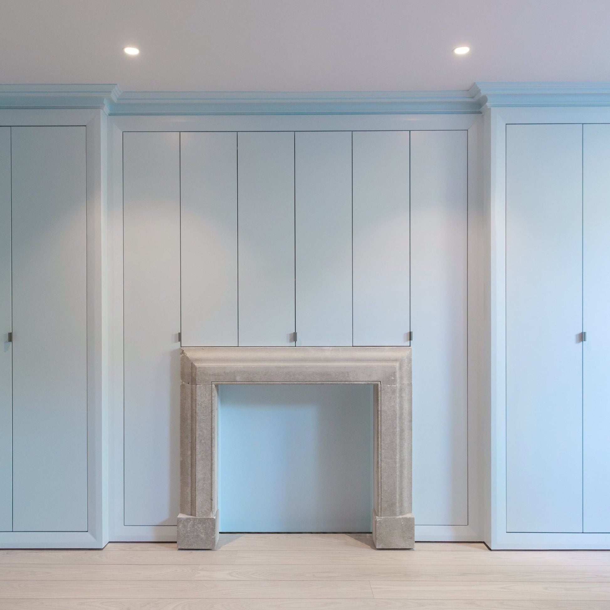 Modern living room with swan neck plaster cornice painted in blue 