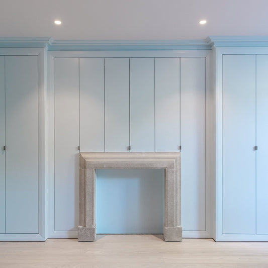 Modern living room with swan neck plaster cornice painted in blue 