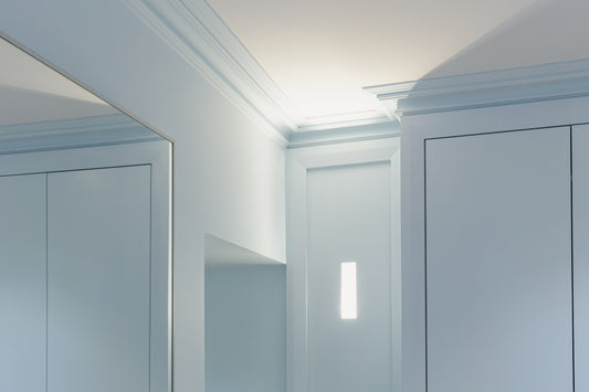 Victorian swan neck plaster cornice installed in modern blue living room