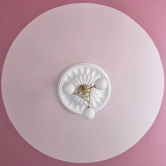 art deco plaster ceiling rose fitted in modern pink room