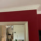 egg and dart plaster coving installed around red chimney breast