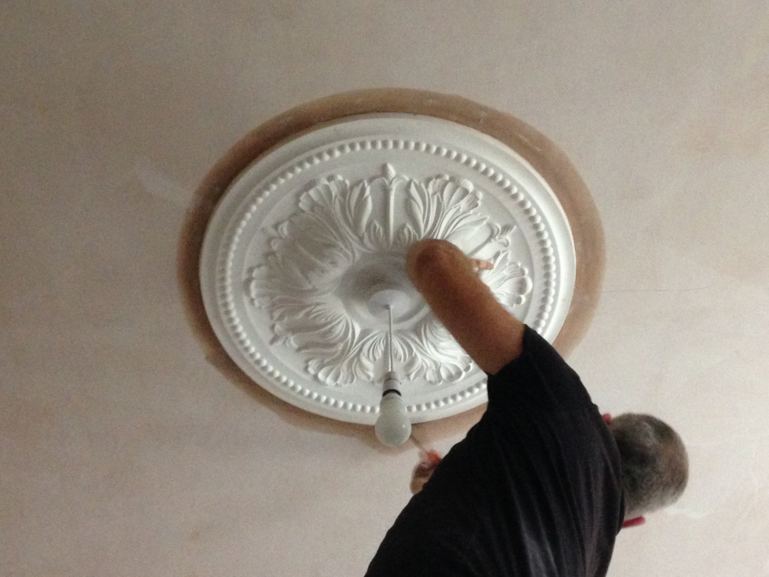 victorian ornate ceiling rose being fitted