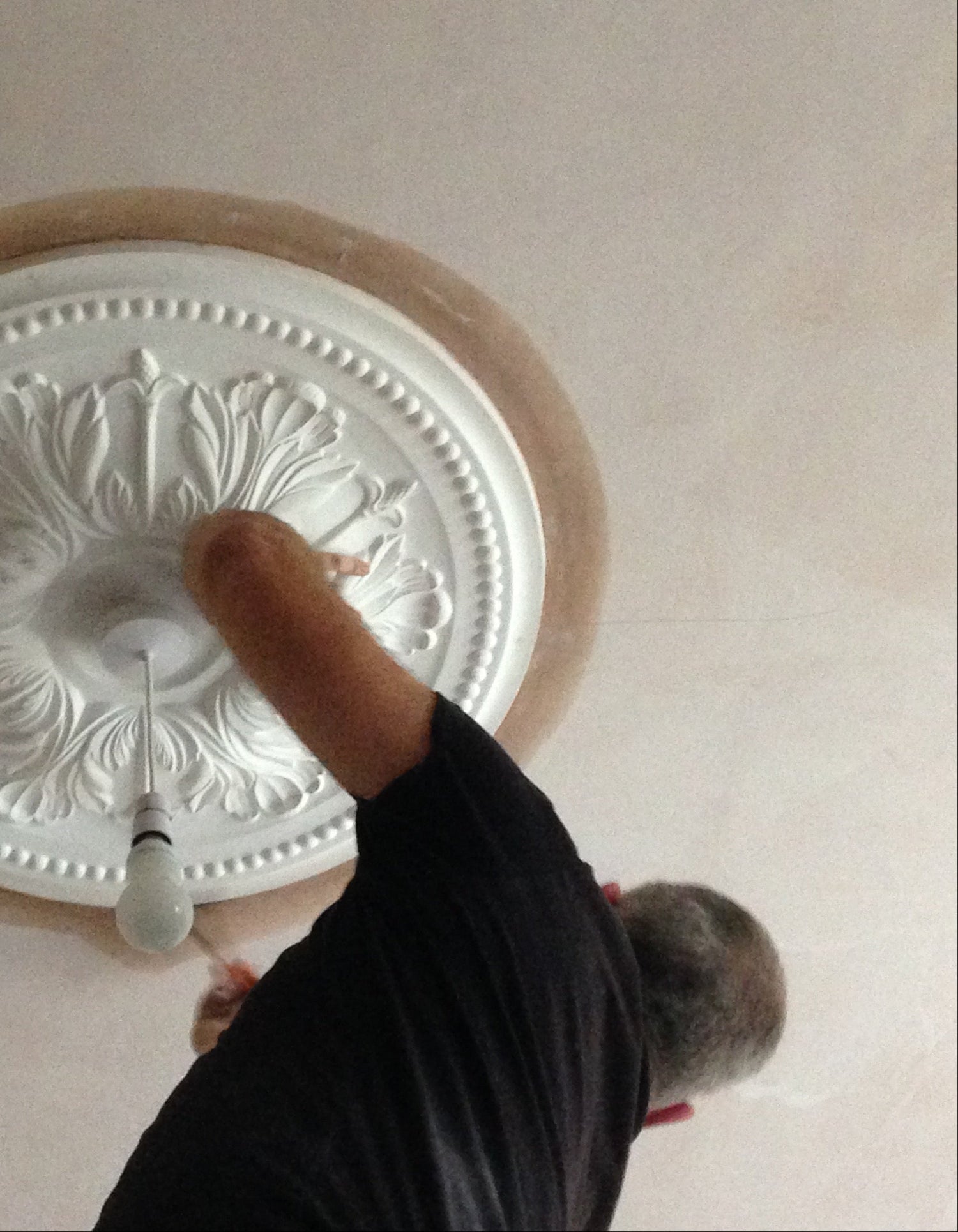 victorian ornate plaster ceiling rose being fitted