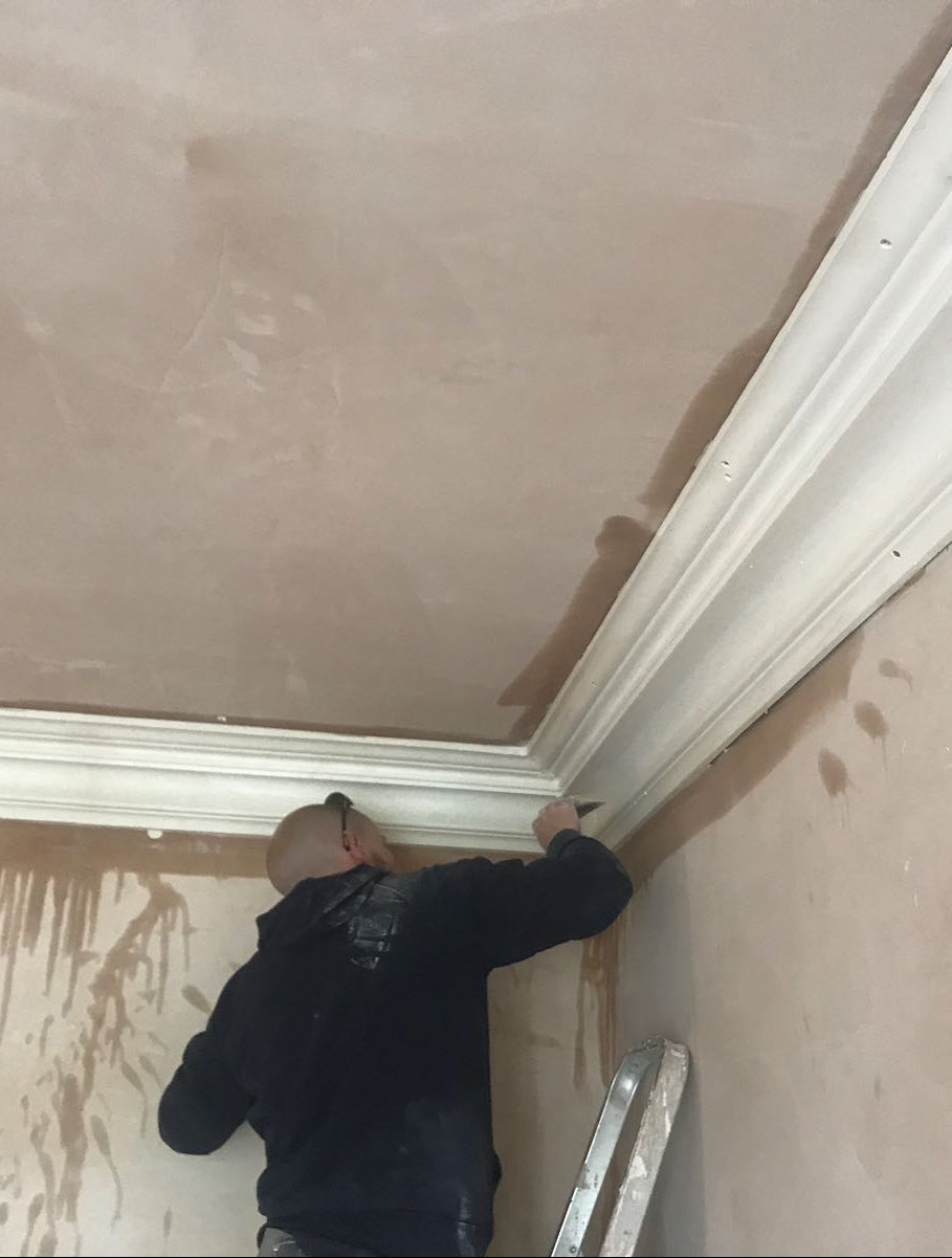 fitter installing coving