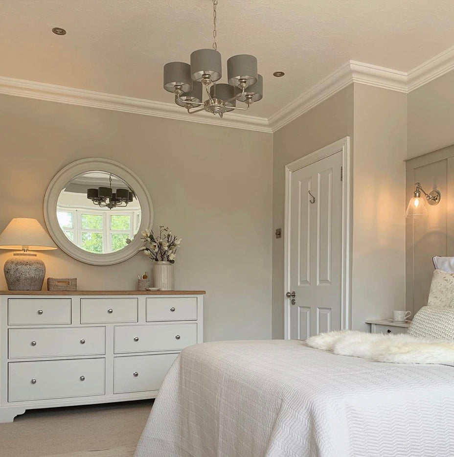 image shows a section of plaster victorian style coving in a cozy bedroom