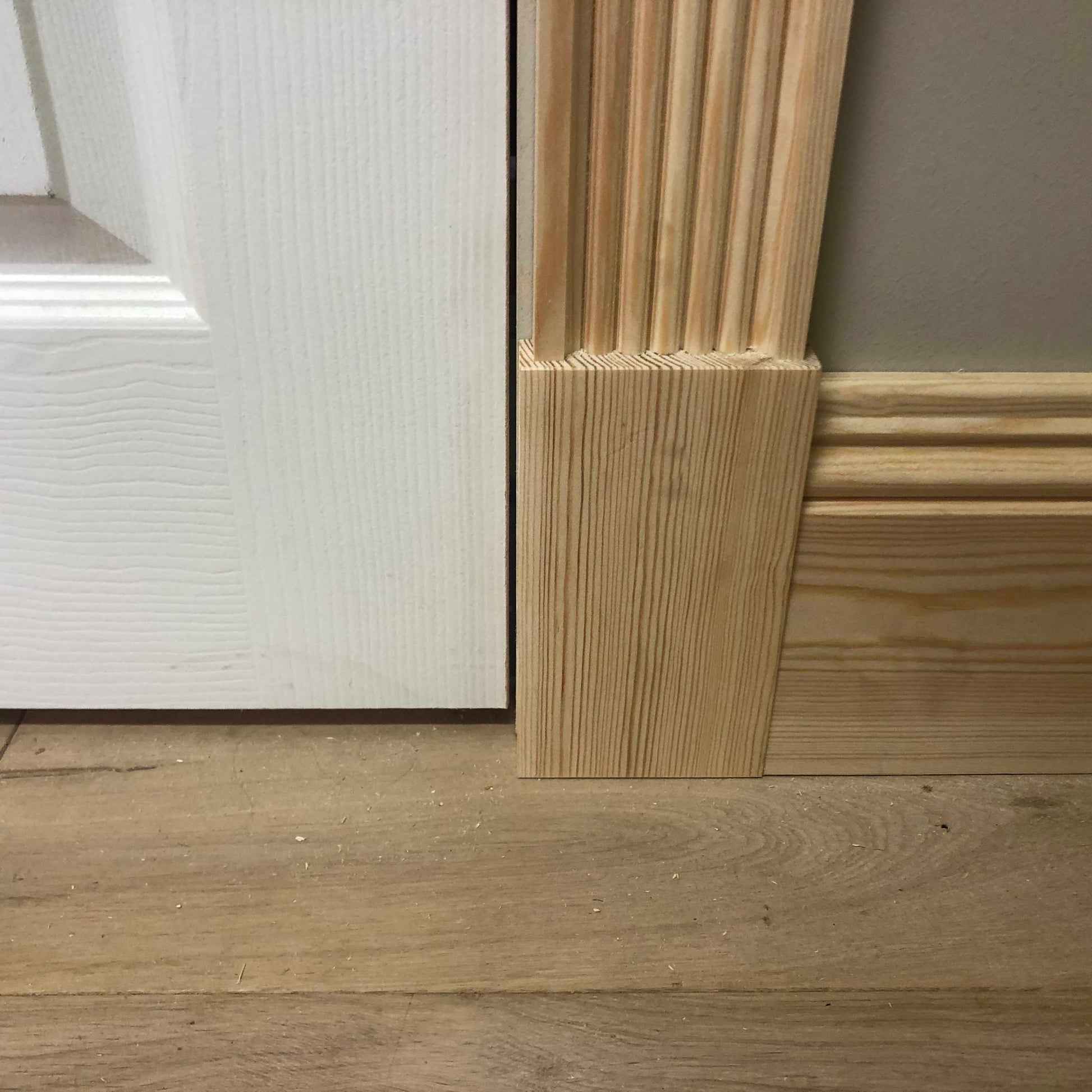 photo of fluted Victorian Timber Architrave meeting skirting board 91mm x 20mm
