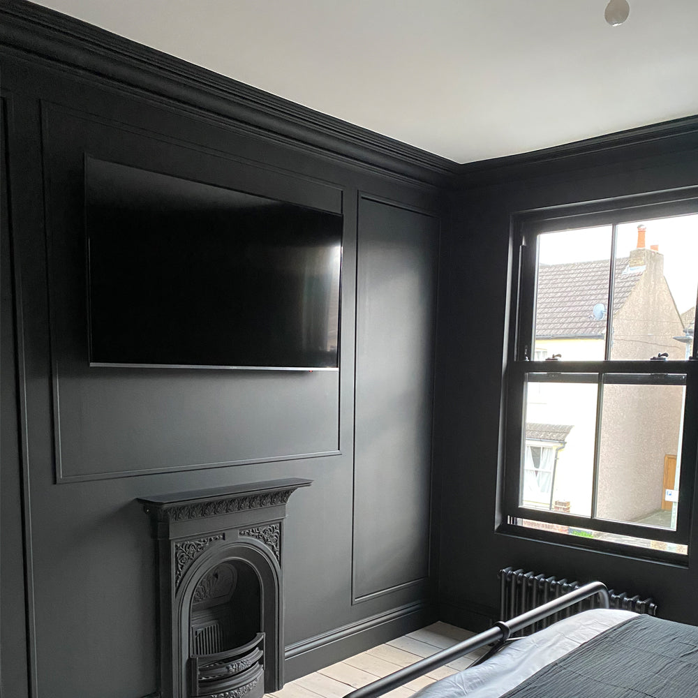 swan neck victorian plaster coving fitted in dark high ceiling bedroom