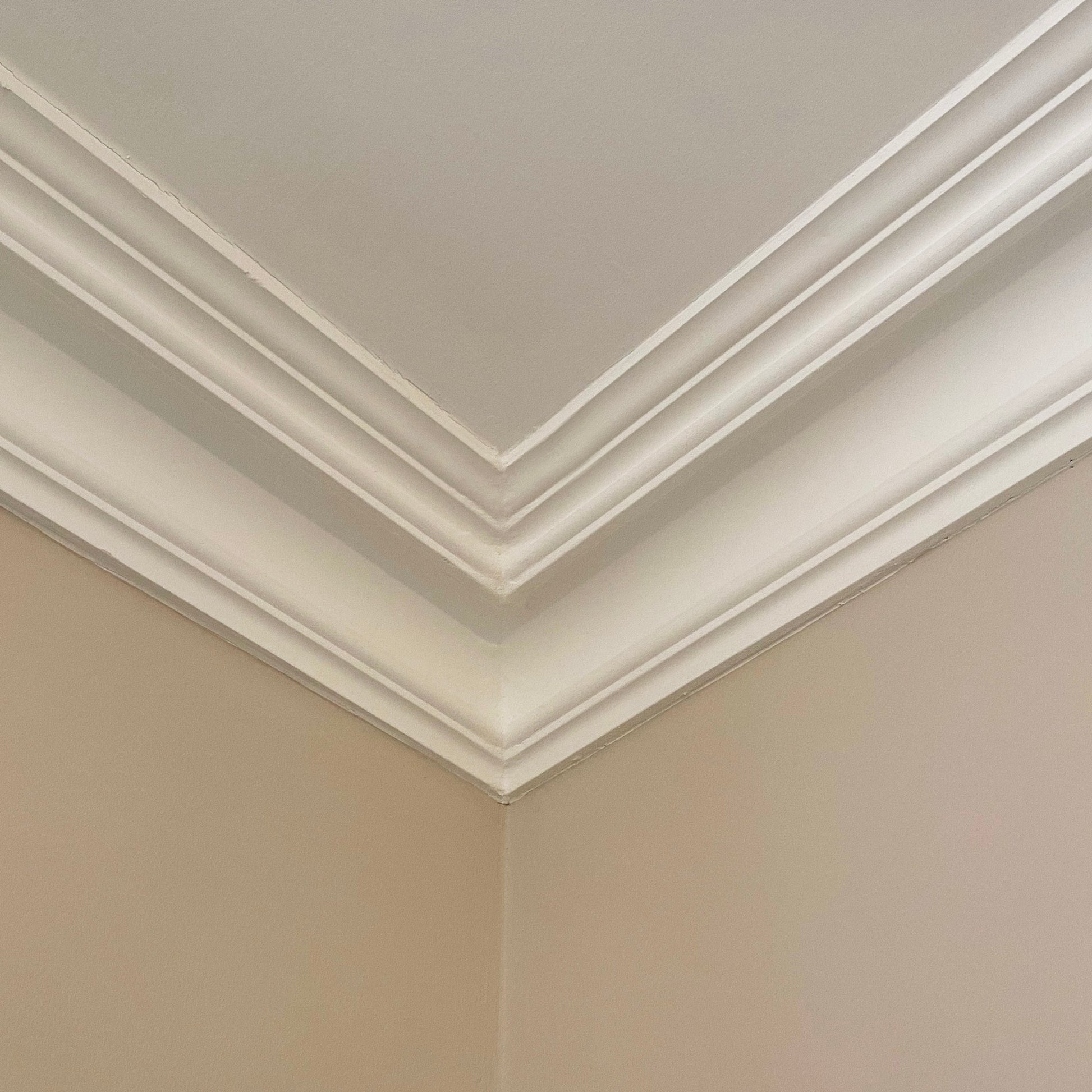 corner of Swan Neck Plaster Cornice, shown with beige wall - 125mm