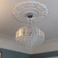 Floral plain centre ceiling rose fitted with chandelier