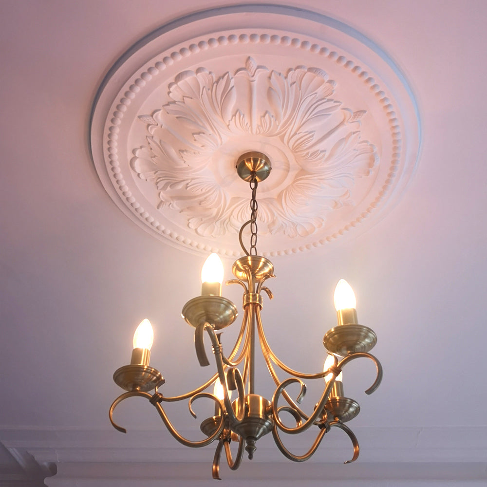 Ornate Floral Plaster Ceiling Rose under warm light