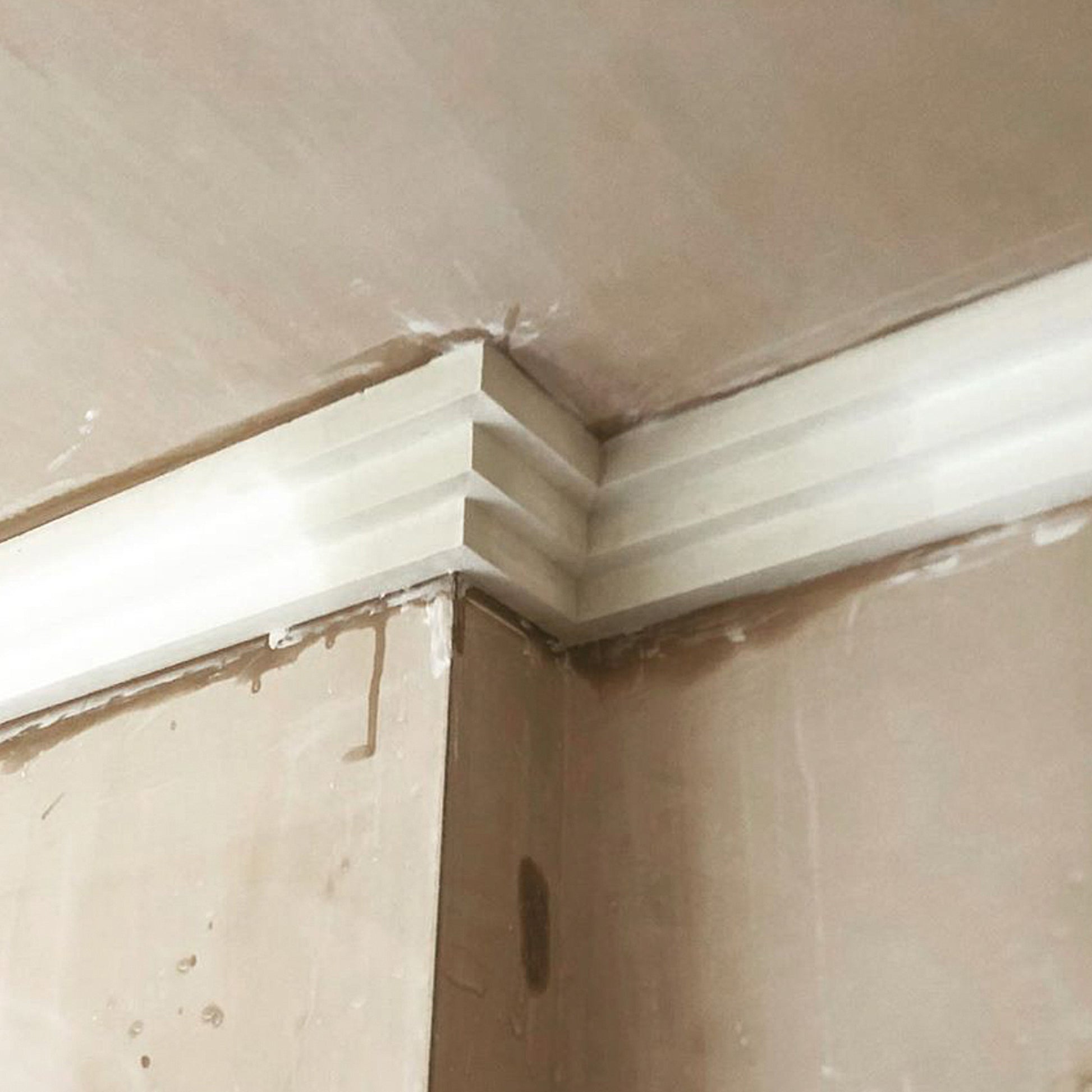 picture showing Three Step Art Deco Plaster Coving being installed - 115mm Drop 