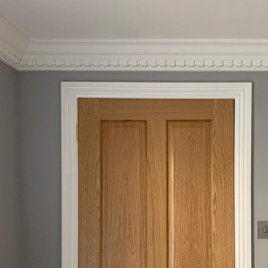 Dentil coving above wooden door