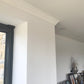 Dentil cornice in light room near door