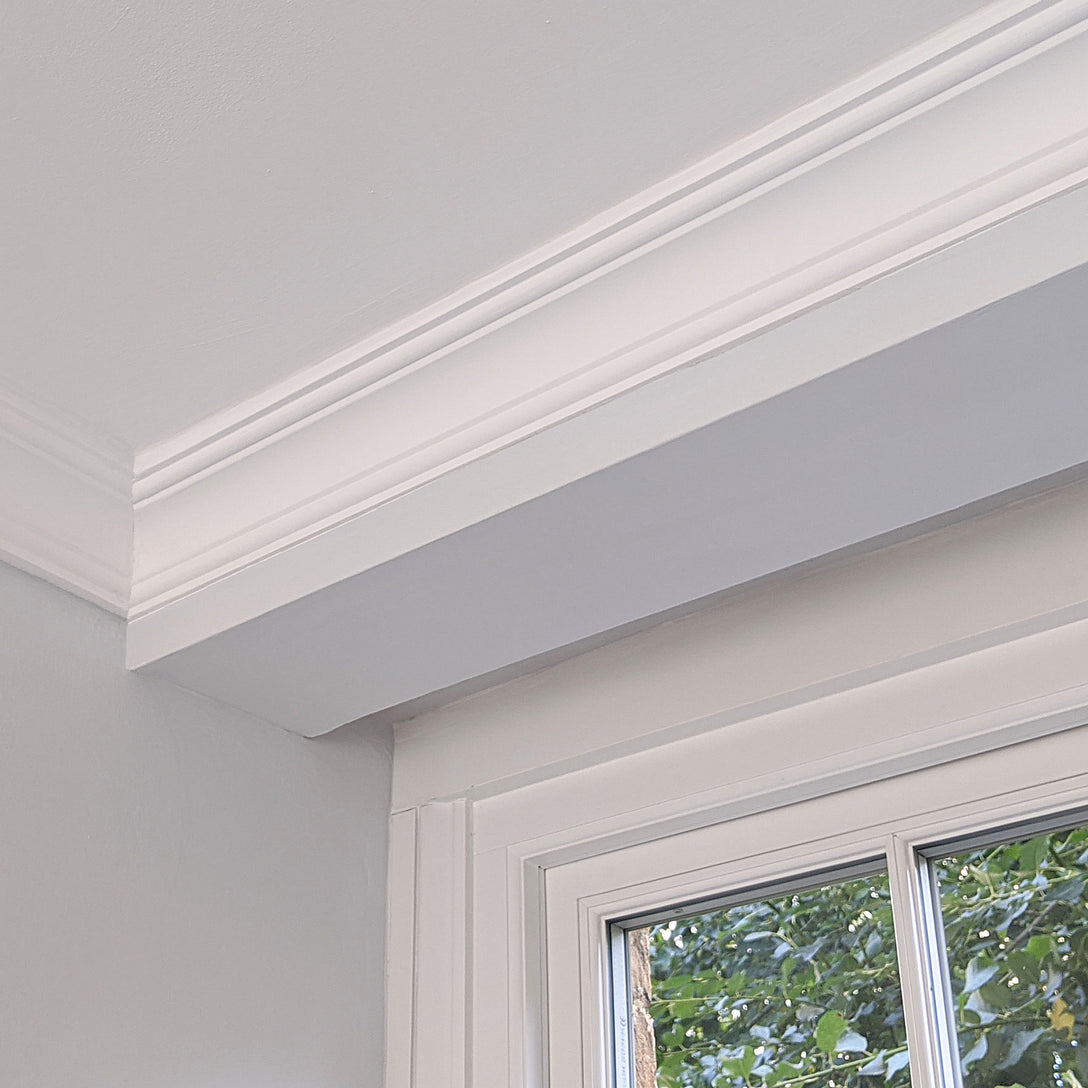 Small cornice above window